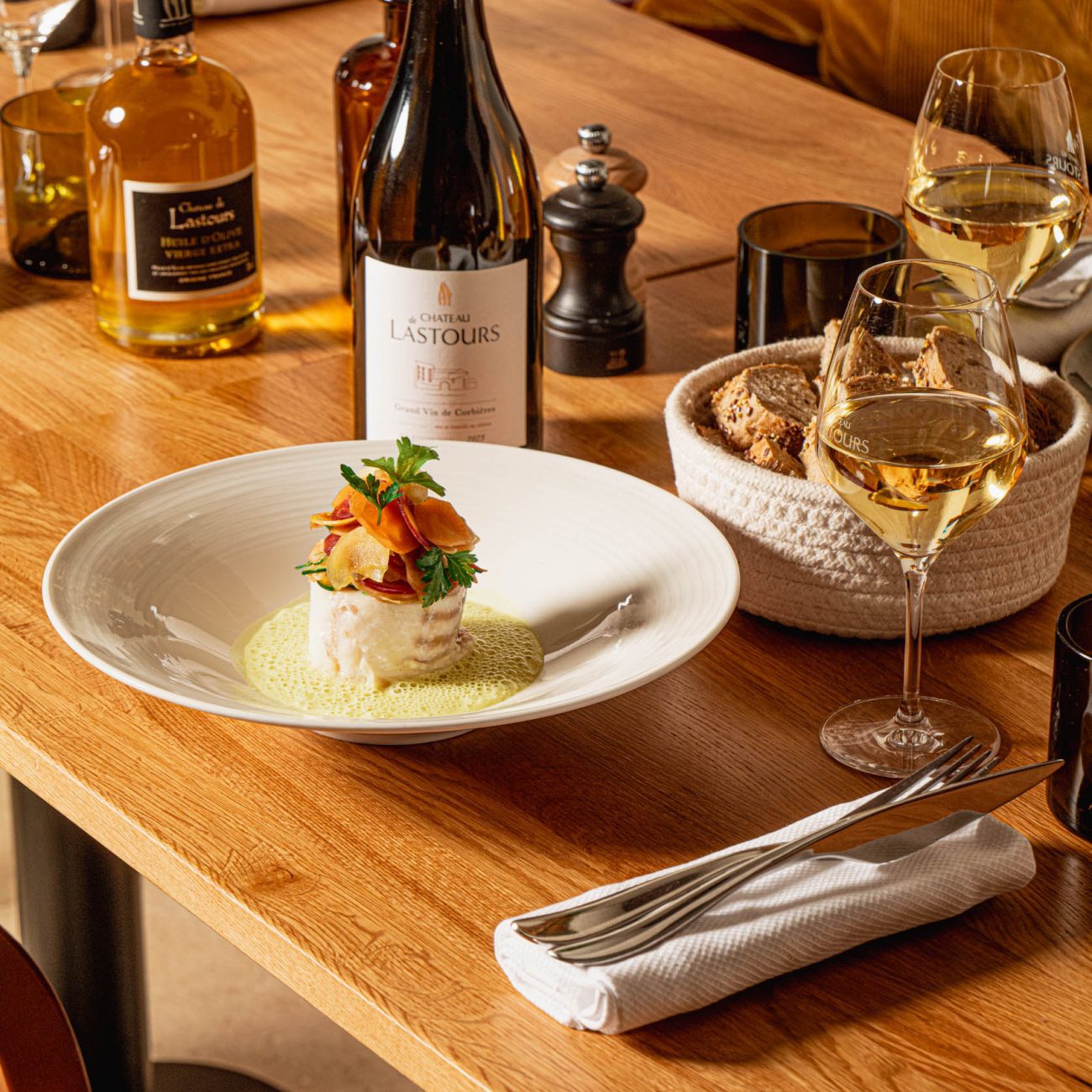 Accord gastronomique au Château de Lastours : poisson raffiné et vin blanc du domaine